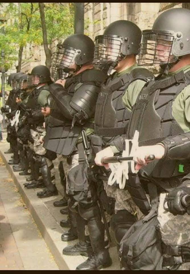 Formation line of tactical officers with protective shields